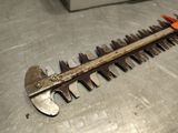a large metal hedger on a table with a pair of scissors