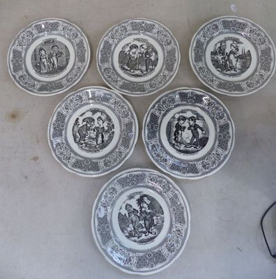 six assiettes ornées de motifs en noir et blanc, posées sur une table