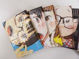trois livres sont empilés sur une table