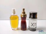 two bottles of perfume sitting next to each other on a table