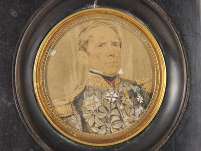 an old picture of a man in a military uniform in a black frame