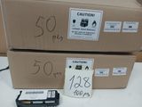 two boxes with labels on them sitting on a table next to a printer
