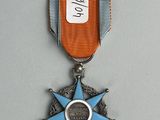 a medal with a star on it on a gray surface