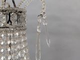 a chandelier hanging from the ceiling with a chain attached to it
