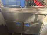 a kitchen with a metal sink and a blue basket on top of it