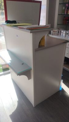 a white counter with a mirror on it in a room