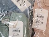 three pairs of pants that are wrapped in plastic