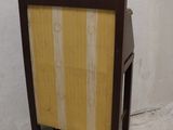 a wooden frame with a yellow and white striped cover