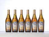 four bottles of wine are lined up on a table