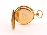an image of a close up of a pocket watch on a white surface