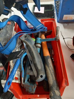 many tools in a red container on a table