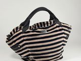 a black and white striped bag with a black handle