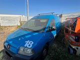 a blue van that is parked in the dirt