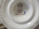 a close up of a white vase with a castle on it