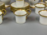 a lot of cups and saucers that are sitting on a table
