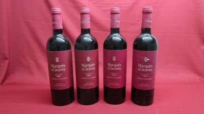 three bottles of red wine are lined up on a pink background