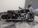 a black motorcycle that is parked on a checkered floor
