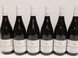 six bottles of wine are lined up in a row on a table