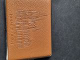an image of a brown leather wallet sitting on top of a black surface