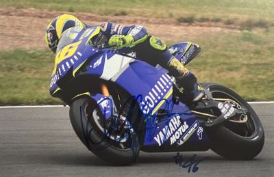 a man that is riding a motorcycle on a track