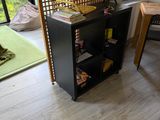 a room with a table, chairs, and a book shelf