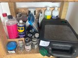 a wooden shelf with various cleaning supplies on top of it