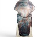 a glass vase that is sitting on a stand