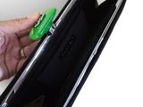 a person holding a wallet with a green object in it