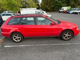 a red car that is parked in a parking lot