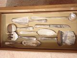 a shadow box with a collection of silverware in it