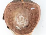 a wooden bowl that has a small bird on it