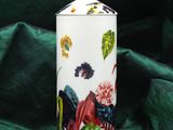 a white jar with a floral design on it