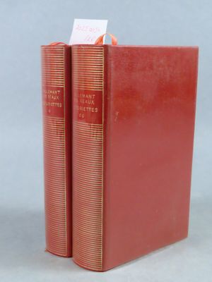 two red books sitting on top of each other on a table