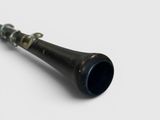 a close up view of a black trumpet on a white surface