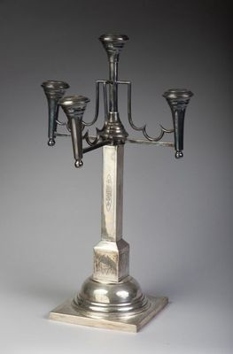 a silver candelab with three candles on it