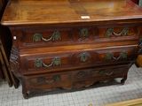 a wooden chest of drawers with a mirror on top of it