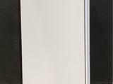picture of a white refrigerator sitting on top of a wooden floor