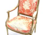 a red and gold chair with a floral pattern on it