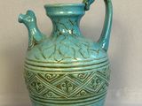 a blue vase that is sitting on a table