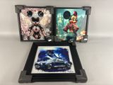 two framed pictures of mickey mouse and a car in front of a white background