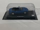 a blue car in a clear case on a white surface