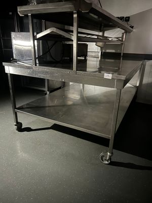 a large stainless steel table in the middle of a room