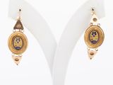 two pairs of earrings with gold and blue designs on them