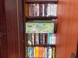 a book case with many books on it in the corner of a room