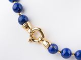 blue lapis beaded necklace with a gold clasp on a mannequin mannequin