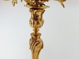 a gold colored candle holder with birds on it