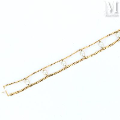 a close up of a gold chain bracelet on a white background