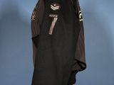 jacket on a mannequin stand with a shadow of a person behind it