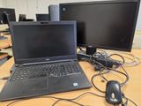 a laptop computer sitting on top of a desk next to a computer monitor