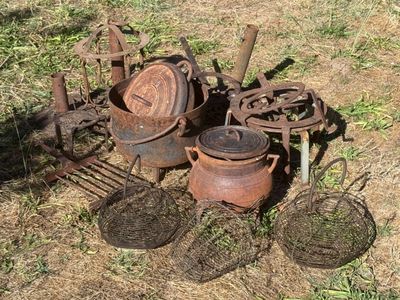 many pots and pans that are sitting on the ground